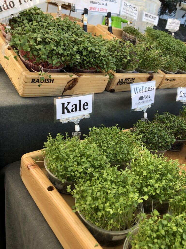 Microgreens displayed in a wood tray